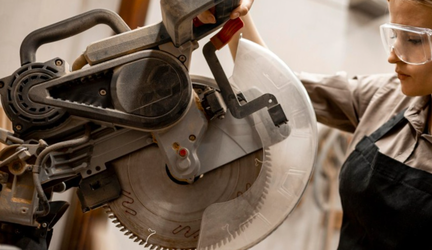 woman using miter saw
